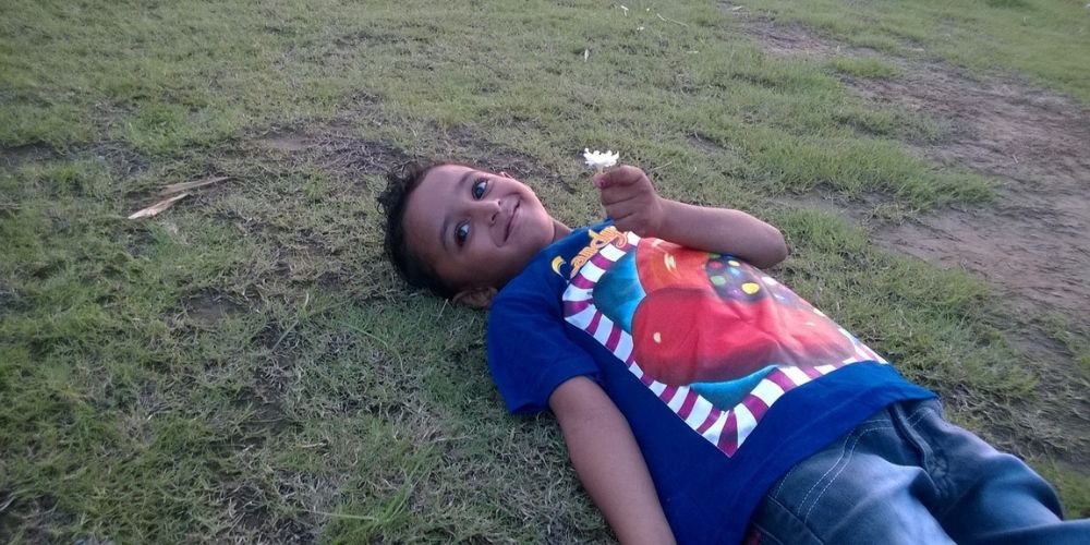 Boy lying on grass