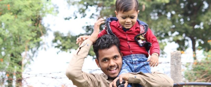 Dad carrying son on his shoulders